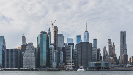 Skyscrapers of downtown Manhattan over East River, viewed from Brooklyn Bridge Park, in Brooklyn, New York, USA