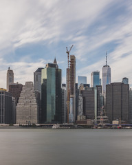 Fototapeta na wymiar Skyscrapers of downtown Manhattan over East River, viewed from Brooklyn Bridge Park, in Brooklyn, New York, USA