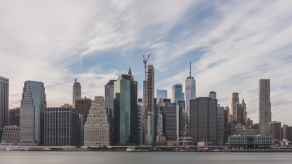 Skyscrapers of downtown Manhattan over East River, viewed from Brooklyn Bridge Park, in Brooklyn, New York, USA