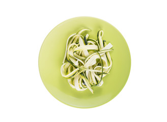 Zucchini pasta on a plate isolated on a white background