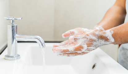 Man washing hands with soap.