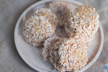 Rice cracker topping with cane sugar on wood plate