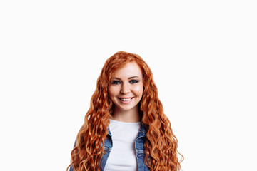 Portrait of beautiful cheerful redhead girl with flying curly hair