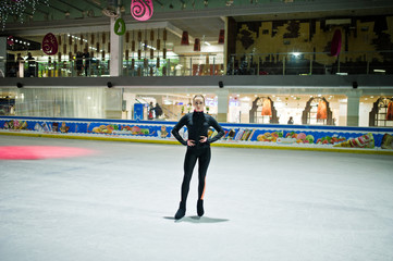Figure skater woman at ice skating rink.