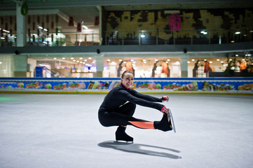 Figure skater woman at ice skating rink.