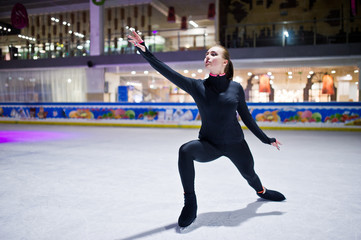 Figure skater woman at ice skating rink.