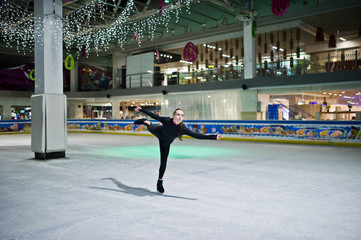 Figure skater woman at ice skating rink.