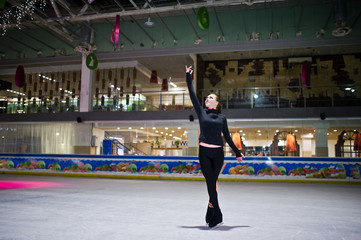 Figure skater woman at ice skating rink.
