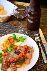 Fried meat with vegetables and sauce on a plate