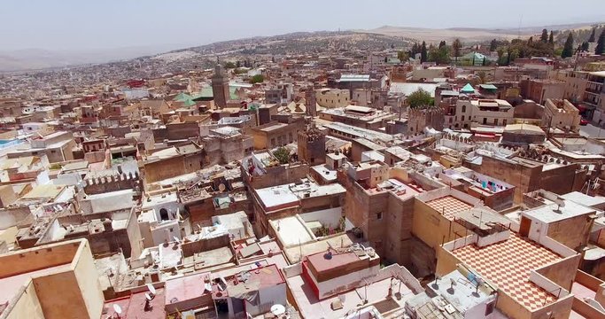 FEZ, MOROCCO. City walls of Fez. Aerial drone 4K view of the medina fortified with crenelated walls and tall watchtowers.