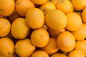 Obraz na płótnie Canvas Fresh mandarin oranges texture. Tangerines as the background. Big bunch of ripe tangerines. Fresh oranges at a local farmers market.