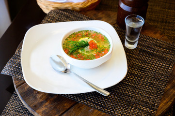 Soup with sturgeon and greens in a plate