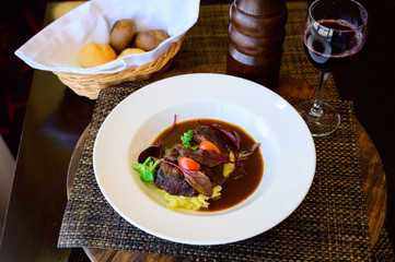Fried meat with potatoes in a soy sauce with vegetables
