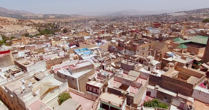 FEZ, MOROCCO. Medieval traditional architecture of the Old Fez. Aerial 4K footage of a car-free urban area with narrow alleyways.