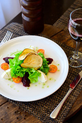 Salad with tomatoes, cheese, lettuce and beet