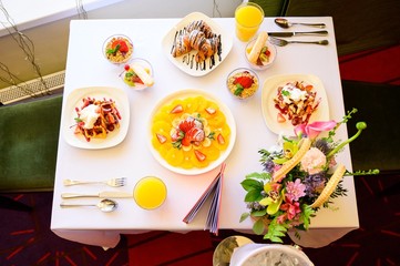 Dessert with croissants, ice cream and sliced fruit