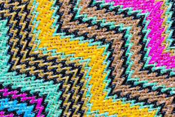 Abstract textured zigzag background of close up detail in woven raffia