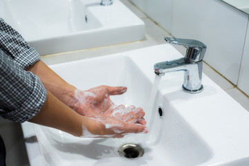 Man washing hands with soap.