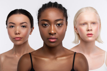 Three women with different complexion posing together