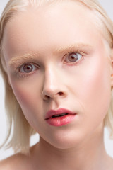 Grey-eyed woman with white skin having strange face expression