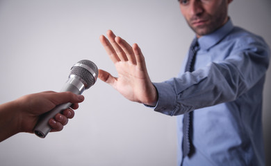  Businessman doing stop gesture. Reporter