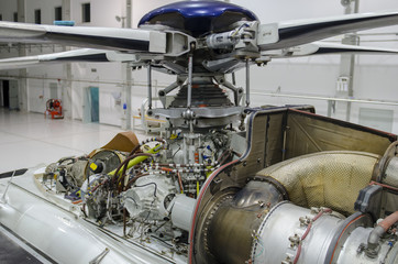 Helicopter engine exposed for maintenance in a Hangar