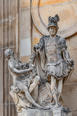 Obraz premium Statue of beautiful naked woman with horn of plenty and Roman soldier in Potsdam University, Germany