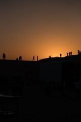 Fototapeta na wymiar silhouette of people in the desert at sunset