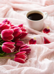 Cup of coffee and pink tulips