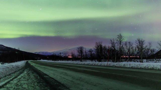 Northern light (aurora borealis) over a road in Norway