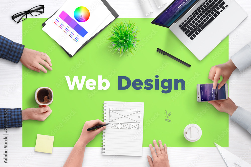Poster Web design text on office desk. Concept of web development team work space. Flat design flat page on laptop and smart phone.