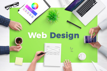 Web design text on office desk. Concept of web development team work space. Flat design flat page...