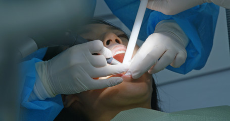 Woman under dental check up in clinic