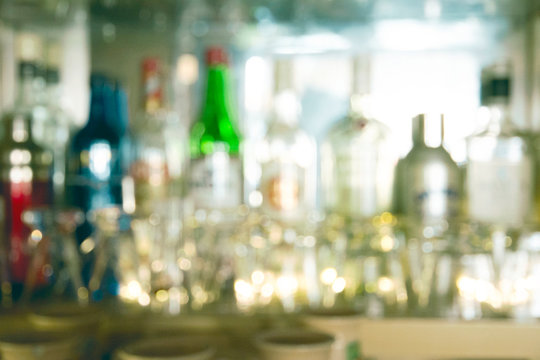 Coaster Under Glass On Blurred Bar Background. Empty The Top Of Wooden Table With Blurred Counter Bar And Bottles Background