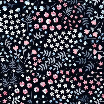 Ditsy seamless floral pattern with small flowers and leaves on black background. Trendy summer design.