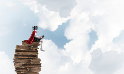 Girl power concept with cute kid guardian against cloudscape background