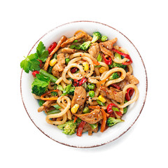 Udon stir fry noodles with pork meat and vegetables in a white plate isolated on white  background.