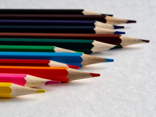 Color pencils on the table on white background.