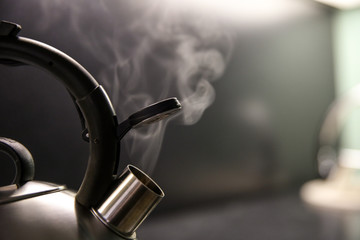 kettle with boiling water. whistle on a boiling kettle closeup. steam from the kettle through the...