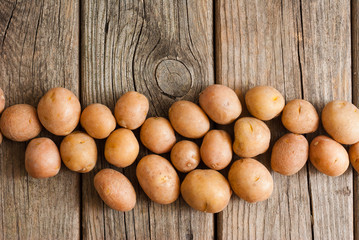 petite potatoes on rustic wood table background