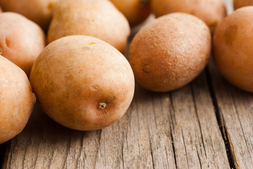 petite potatoes on rustic wood table background