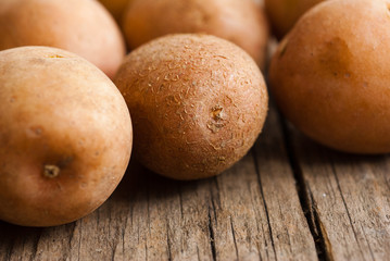 petite potatoes on rustic wood table background