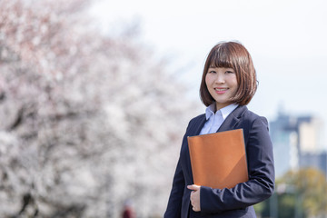 Fototapeta premium 桜とスーツの女性