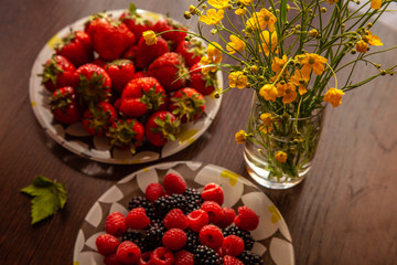 Obraz na płótnie Canvas Very tasty food -Strawberry and raspberry and flowers nature morte