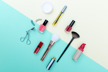 Decorative cosmetics, makeup products and brushes on pastel blue color background