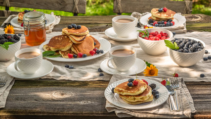 Tasty pancakes with fresh blueberries and honey