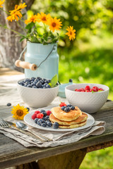 Sweet pancakes for breakfast in sunny garden