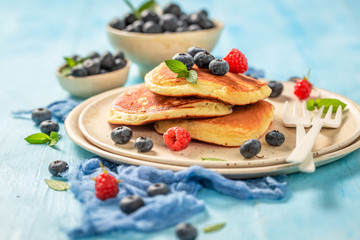 Delicious american pancakes with fresh blueberries and sugar