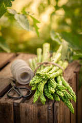 Fresh green asparagus on old wooden box