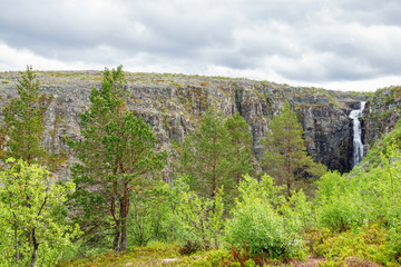 Fototapeta na wymiar Beautiful mountain landscape with a waterfall in a ravine